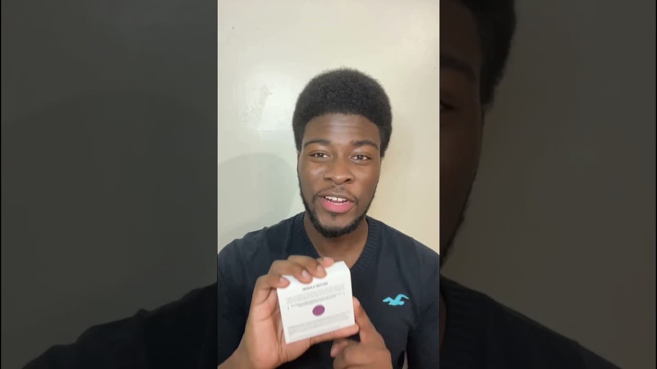 POJO customer holding a packaged Nebula Nectar body bar